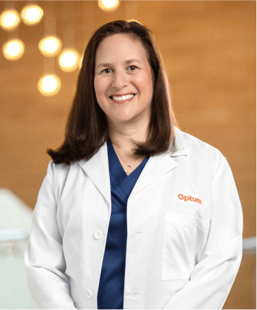Smiling female doctor in an Optum white coat