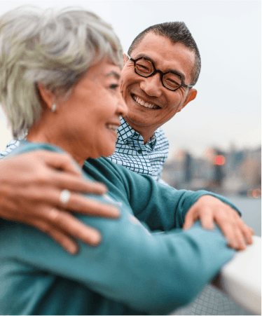 Happy senior couple embracing outdoors, representing wellness and Medicare support with Optum OR
