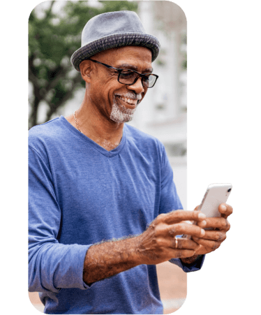 Smiling senior man in a hat using his smartphone, representing Medicare support with Optum OR